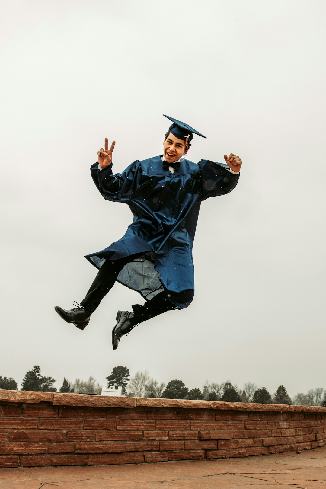 Man jumping in the air after graduating university